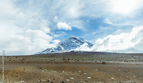 Panoramic shot of Chimborazo Volcano in a blue sky with clouds. Concept travel in Ecuador, South America