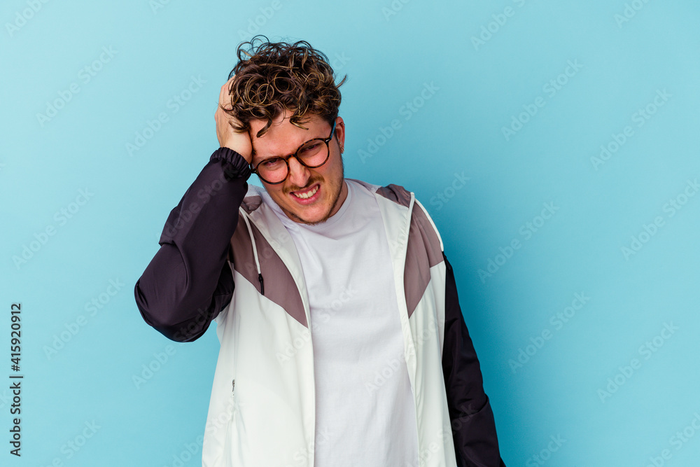 Young caucasian man wearing eyeglasses isolated on blue background celebrating a victory, passion and enthusiasm, happy expression. Young caucasian man wearing eyeglasses isolated on blue background celebrating a victory, passion and enthusiasm, happy expression.