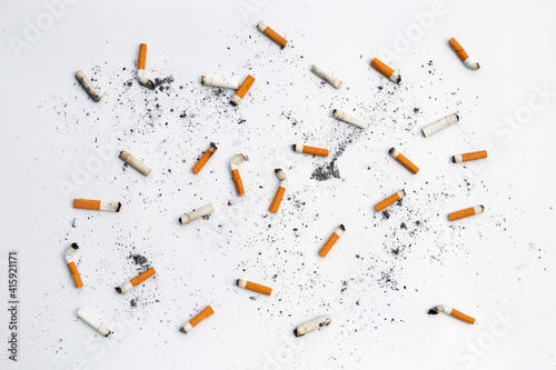 Cigarette butts and ashes on white