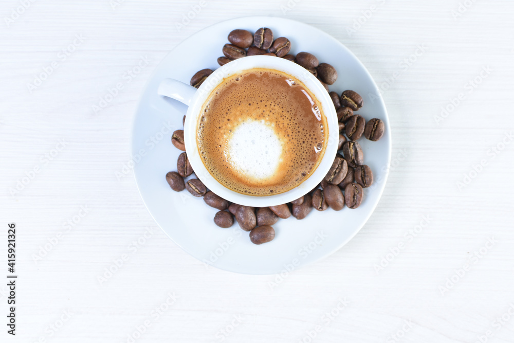 Obraz premium Cup of colombian coffee, decorated on white wooden background