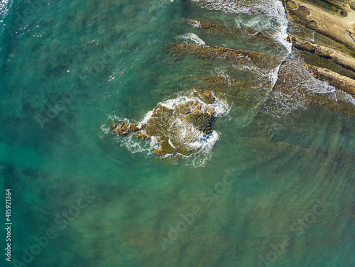 Aerial drone view of the rocks of Cabo Huertas beach in Alicante, located in the Valencian Community, Spain