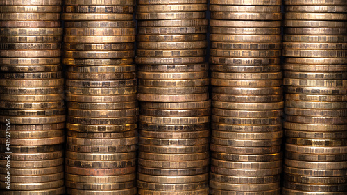 Full-screen background of stacks of abstract yellow brass coins