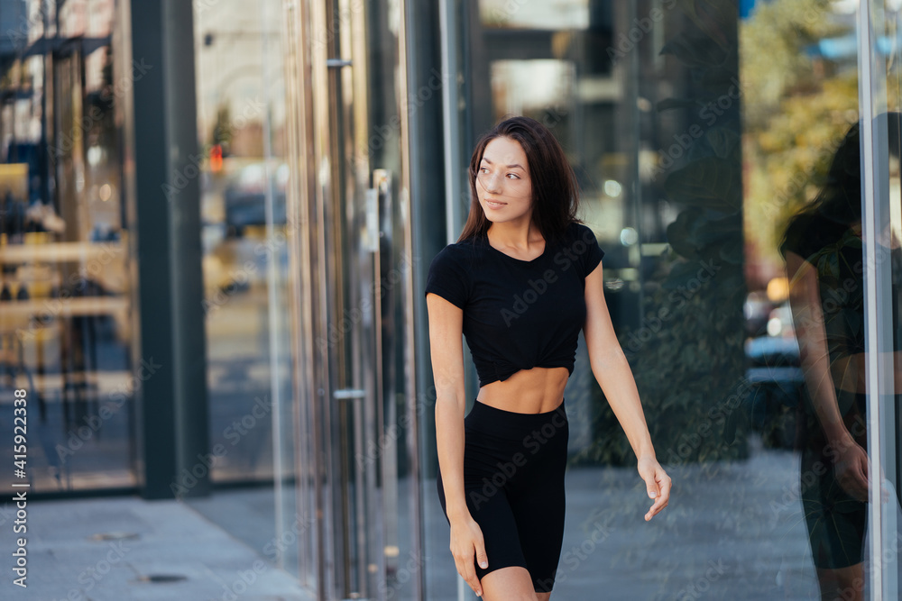 Fototapeta premium Beautiful woman, summer in city, fitness training on street.