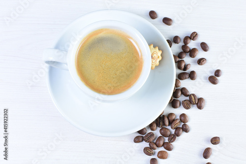 Cup of colombian coffee, decorated on white wooden background
