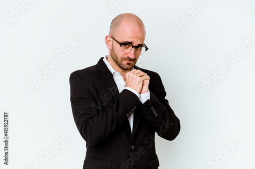 Young business caucasian bald man isolated on blue background scared and afraid.