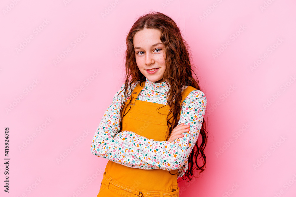 Little caucasian girl isolated on pink background who feels confident, crossing arms with determination. Little caucasian girl isolated on pink background who feels confident, crossing arms with determination.