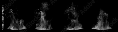 Set of steam from round dishes - pots, mugs or cups isolated on black background photo