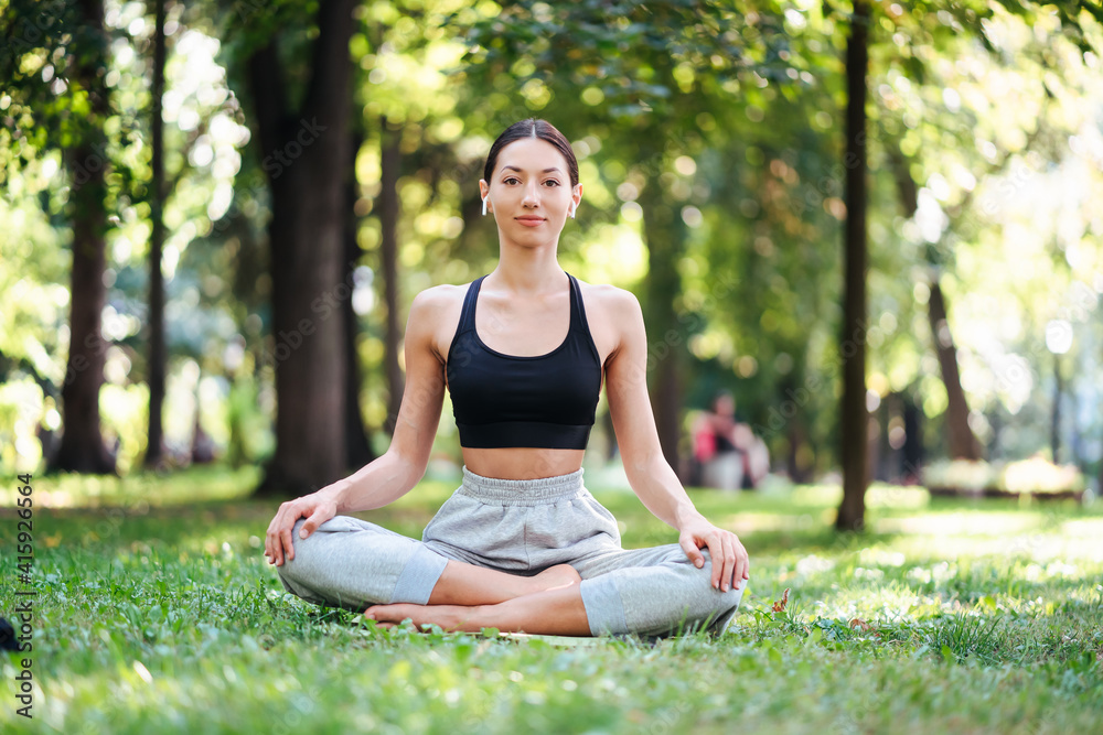 Fitness girl with a smartphone on nature background. Fitness girl with a smartphone on nature background.