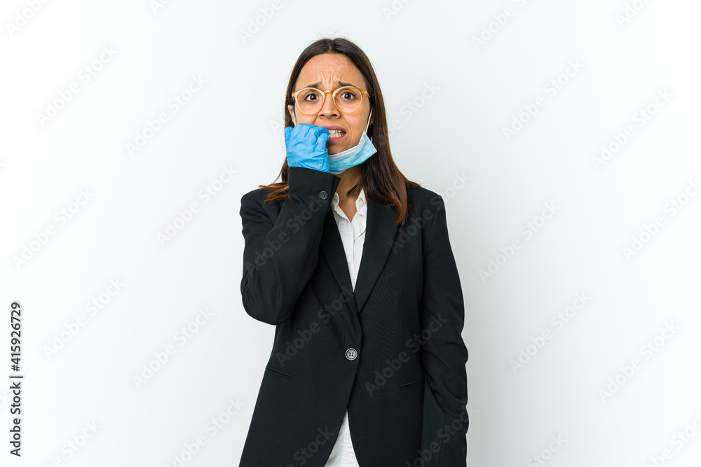 Young business latin woman wearing a mask to protect from covid isolated on white background biting fingernails, nervous and very anxious. Young business latin woman wearing a mask to protect from covid isolated on white background biting fingernails, nervous and very anxious.