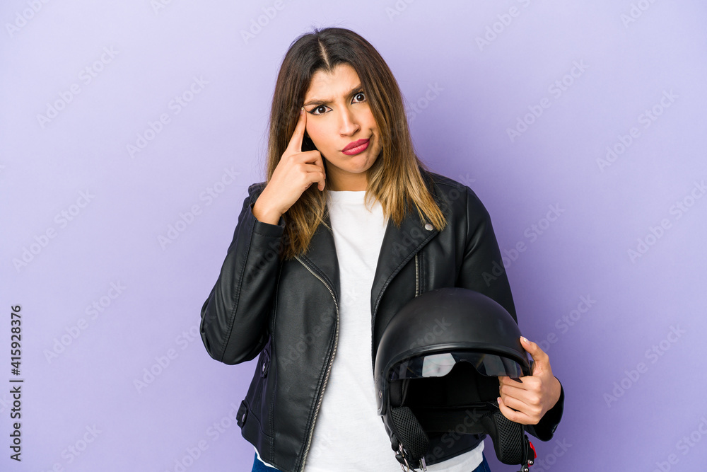 Young indian motorbiker woman isolated showing a disappointment gesture with forefinger. Young indian motorbiker woman isolated showing a disappointment gesture with forefinger.