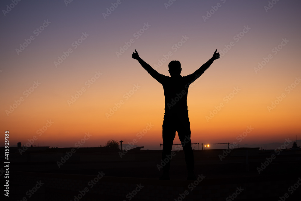 A man embraces the sunrise in the east