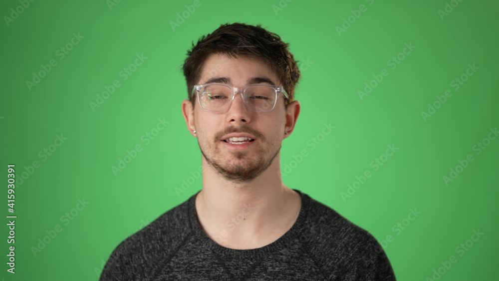Cheerful hip man having a video chat, as seen from the point of view of a computer screen. Isolated on green screen chroma key. Concept remote video chat with friends family.