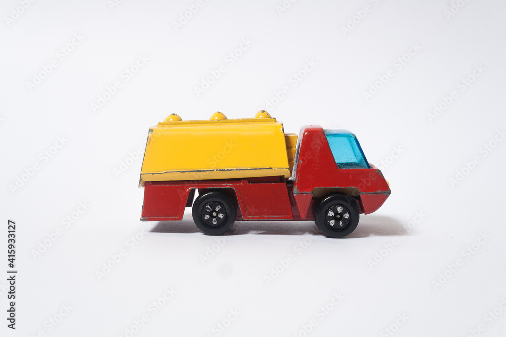 old red and yellow children's toy car, side view
