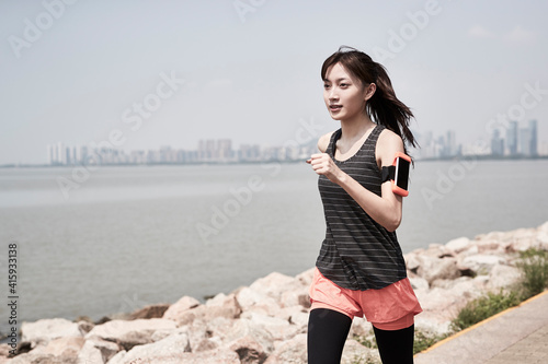 young asian woman jogging outdoors