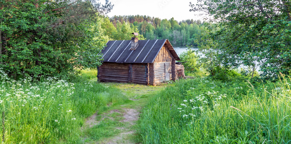Sauna wooden baths or banya cabin on lake shore Sauna wooden baths or banya cabin on lake shore