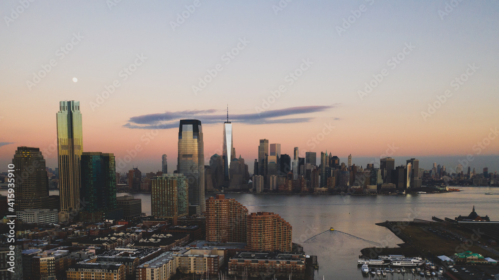 Sunset Aerial View Clouds and Picture of Hudson River, Jersey City, and Financial District of Manhattan, New York City Skyline City Architecture