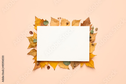 Flat lay composition with autumn leaves and blank card on light background  space for text