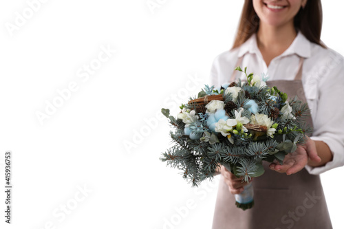 Florist holding beautiful winter wedding bouquet on white background, closeup
