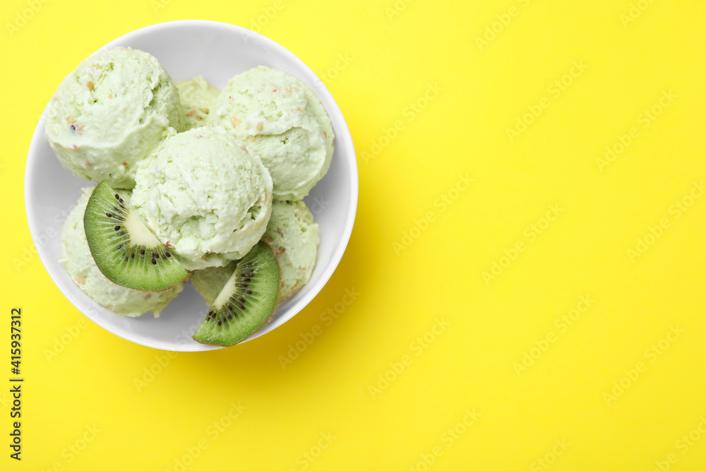 Delicious kiwi ice cream on yellow background, top view. Space for text