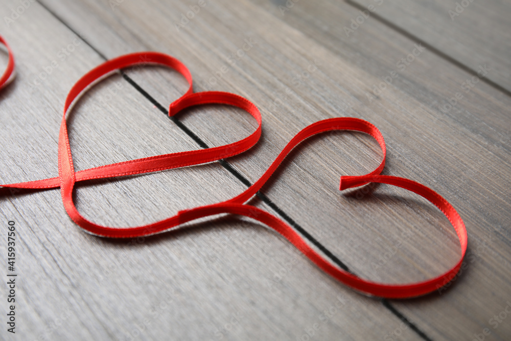 Hearts made of red ribbon on wooden background. Valentine's day celebration Hearts made of red ribbon on wooden background. Valentine's day celebration
