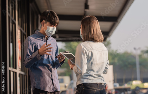 New normal, People wear facemask protect coronavirus talking business by tablet technology