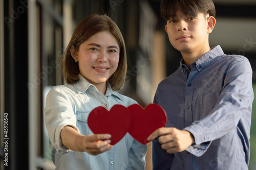 Asian couple holding red heart ,People happy sweet love Valentine, health insurance , Giving Love together
