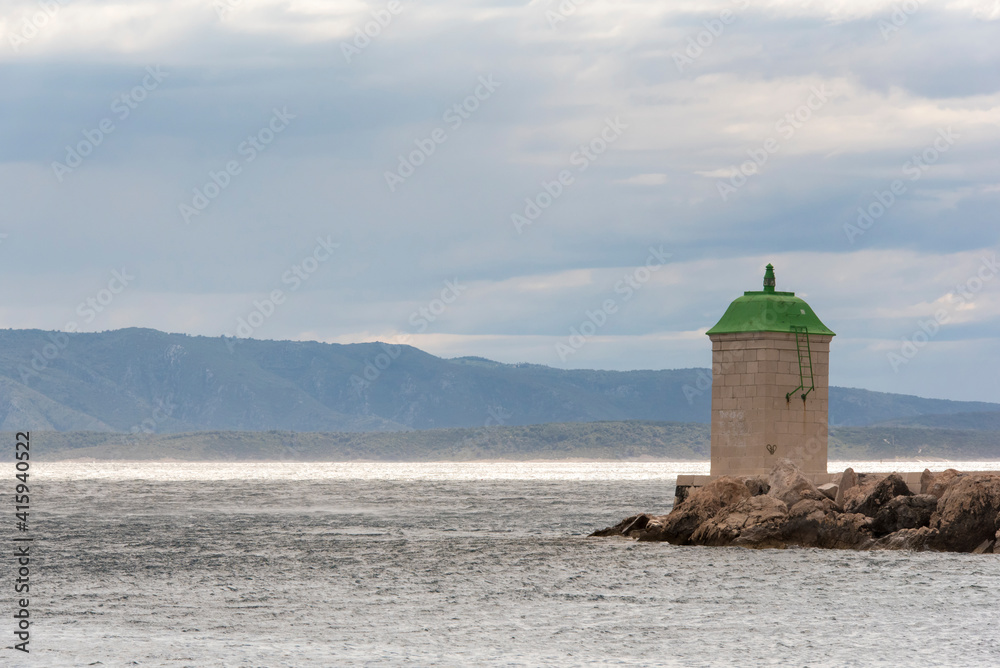 Croatia, Brac Island, Bol. Lighthouse marks entrance marina.