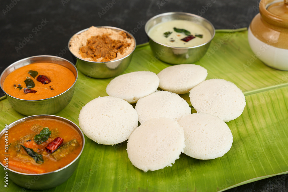 Many Idli idly sambar coconut chutney , tomato chutney serving