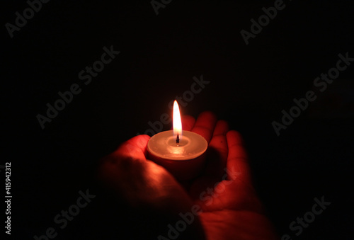 the candlelight on hand in the dark room
