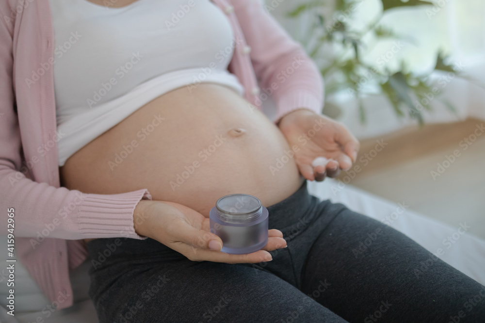 Motherhood Asian Young Pregnant Woman Applying Pregnancy Lotion Prevent Stretch Marks On Belly 