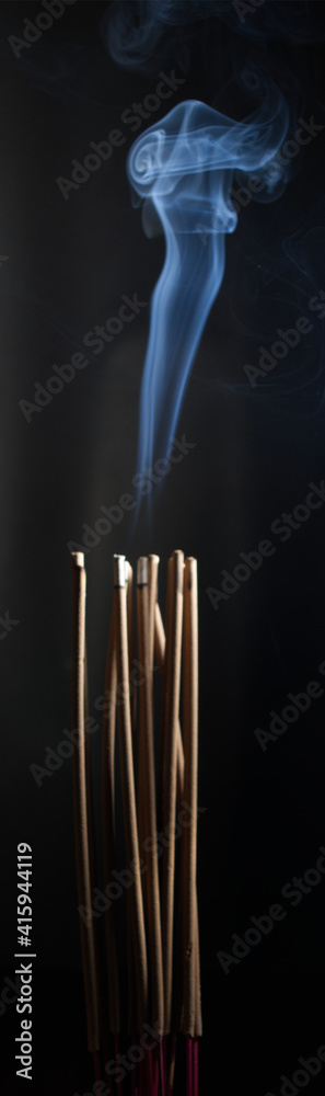 Incense burning incense, white smoke, black background, used as background image Paying homage to the sacred objects of the people of Buddhism according to their beliefs and beliefs. Incense burning incense, white smoke, black background, used as background image Paying homage to the sacred objects of the people of Buddhism according to their beliefs and beliefs.