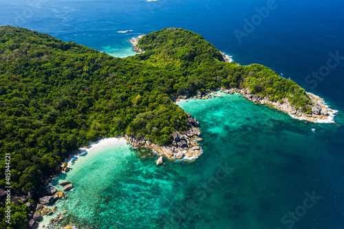 Aerial view drone shot ocean waves, Beautiful tropical beach and rocky coastline and beautiful forest. Nga Khin Nyo Gyee Island Myanmar. Tropical seas and islands in southern Myanmar photo