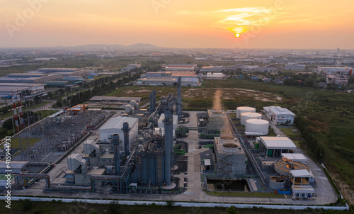 Aerial view drone of oil storage tank with oil refinery factory industrial. Oil refinery plant at beautiful sky sunset and twilight. industry factory concept and transportation.