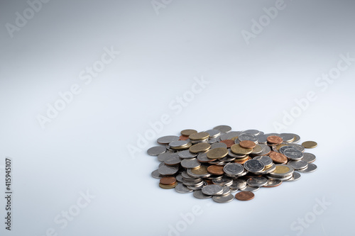 A pile of Thai baht coins isolated on a white background.