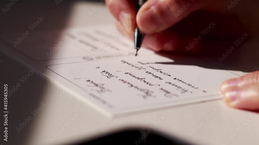 Calligraphy Ink Writing a Postcard in Russian Close Up. Natural Fingers Pen Writing a Letter. Bokeh Effect Zoom In Calligraphy Ink Writing a Postcard in Russian Close Up. Natural Fingers Pen Writing a Letter. Bokeh Effect Zoom In