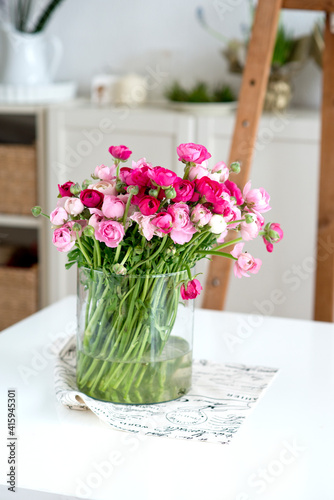 bouquet of ranunculus flowers in glass  vase