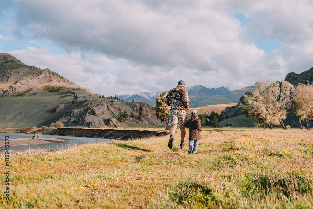 Fototapeta premium father and son running on the country road