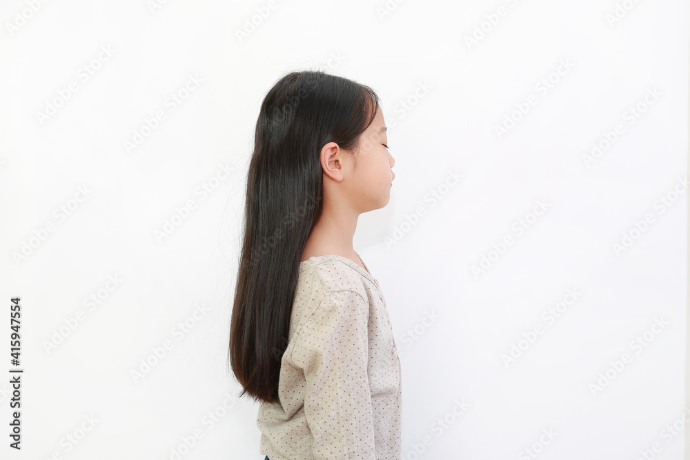 Peaceful Asian little girl closed eyes isolated on white background. Portrait of kid with long black hair, Side view Peaceful Asian little girl closed eyes isolated on white background. Portrait of kid with long black hair, Side view