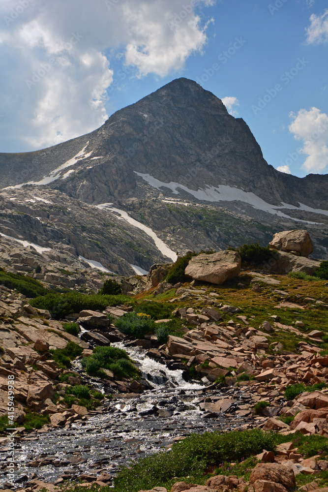 magnificent arapahoe, navajo, and shoshoni peaks with a mountain stream and snowfield on a sunny summer day along the lake isabele trail in the indian peaks wilderness area near nederland, colorado magnificent arapahoe, navajo, and shoshoni peaks with a mountain stream and snowfield on a sunny summer day along the lake isabele trail in the indian peaks wilderness area near nederland, colorado