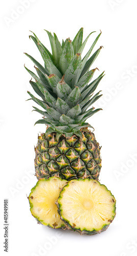 Whole pineapple and pineapple slice on white background