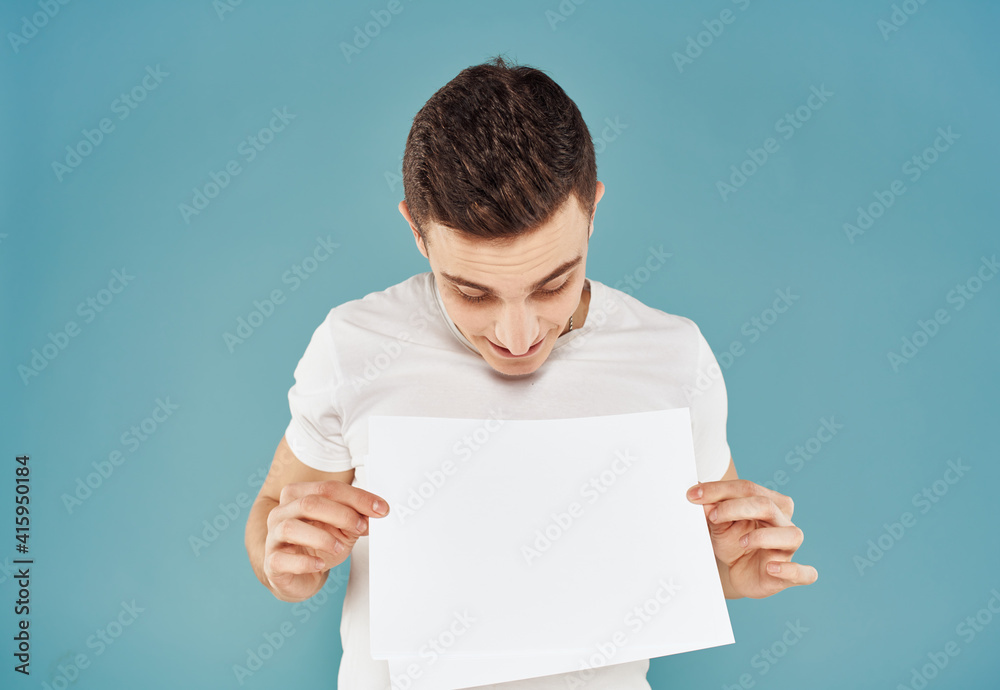 Male advertiser with a white sheet of paper on a blue background mockup Flyer Male advertiser with a white sheet of paper on a blue background mockup Flyer