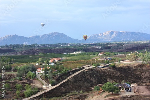 Colorful hot air balloon flying on blue sky background at Temecula in California. aerial view - 米国 カリフォルニア テメキュラ 気球  photo