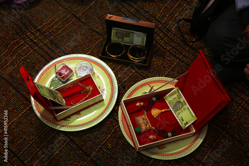 Golden gewellery set opened box gifted to bride in Indian wedding with currency notes