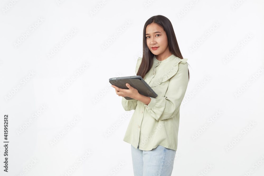 Beautiful young woman holding digital tablet and looking at camera with smile while standing. Wireless technology. Beautiful young woman holding digital tablet and looking at camera with smile while standing. Wireless technology.