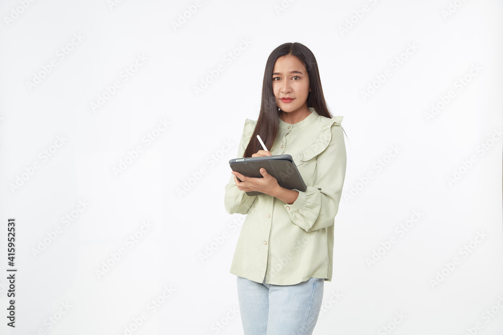 Beautiful young woman holding digital tablet and looking at camera with smile while standing. Wireless technology. Beautiful young woman holding digital tablet and looking at camera with smile while standing. Wireless technology.