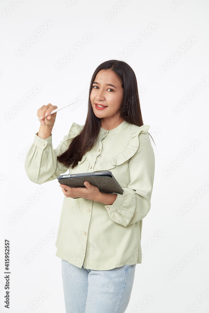 Beautiful young woman holding digital tablet and looking at camera with smile while standing. Wireless technology. Beautiful young woman holding digital tablet and looking at camera with smile while standing. Wireless technology.
