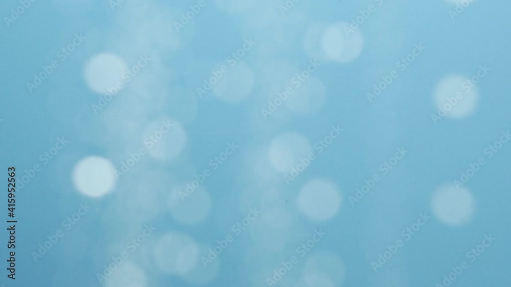 Blurred moving abstract white color light particles, blue background, lens flare Blurred moving abstract white color light particles, blue background, lens flare