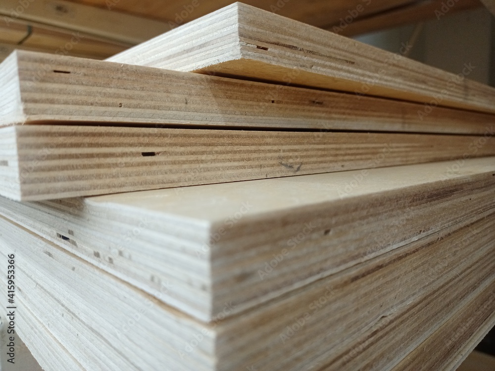 A stack of plywood sheets for construction. A pile of wooden chipboard