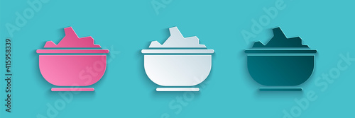 Paper cut Sea salt in a bowl icon isolated on blue background. Paper art style. Vector Illustration.