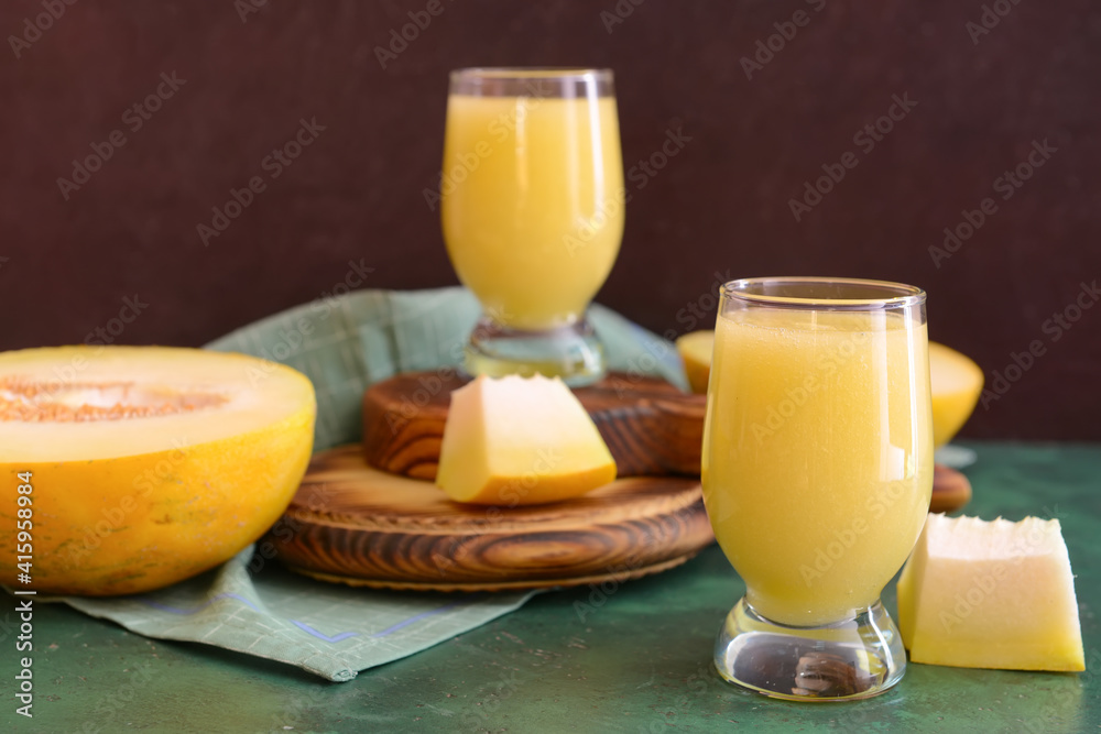 Glasses with melon smoothie on color table Glasses with melon smoothie on color table